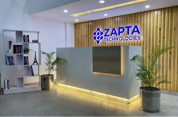 A team of software developers working in the ZAPTA Technologies office building in Lahore, Pakistan. The developers are working on a custom software development project, using various tools and technologies to create a high-quality software solution. The image is relevant to the keywords "about us," "custom software development company," "web development company," "mobile app development company," "application development company," "IT consulting company," "IT services company," "IT solutions company," "IT outsourcing company," "quality assurance," "mobile apps," "data analytics," "artificial intelligence," "machine learning," "MVP builder," "dedicated teams," "history of ZAPTA," and "ZAPTA office building."