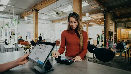 Customer paying at a counter with a tablet point of sale
