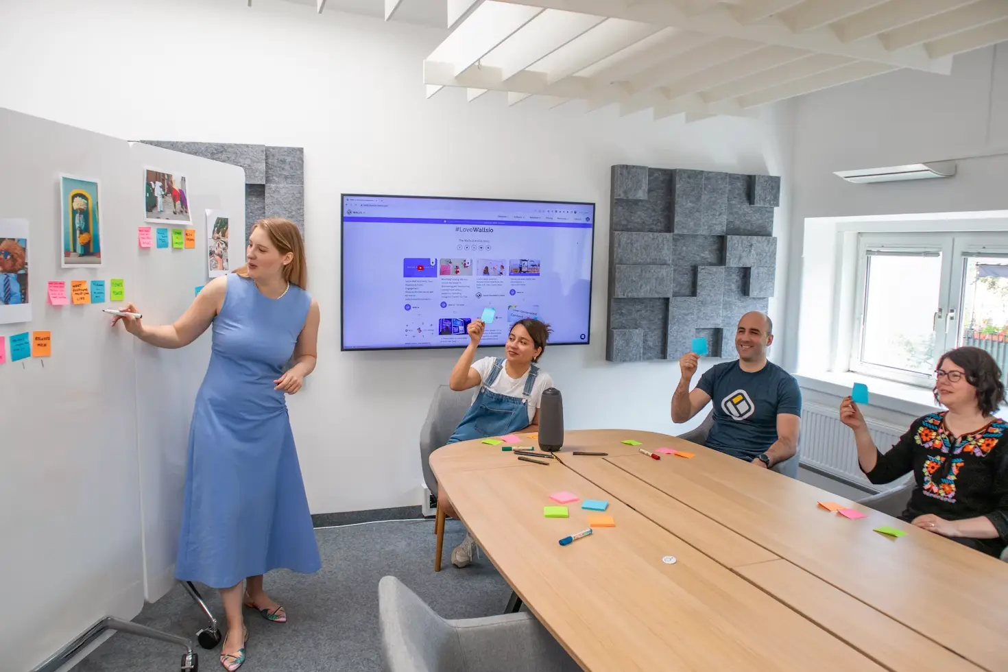 Product team planning session with sticky notes and a screen