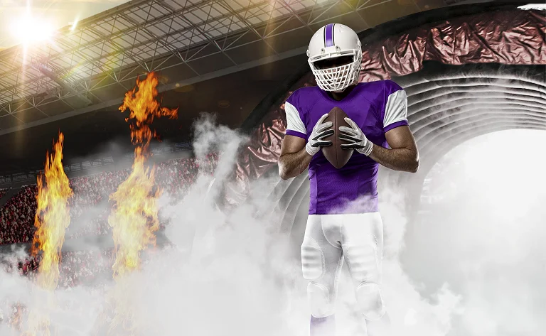 american football player standing in stadium