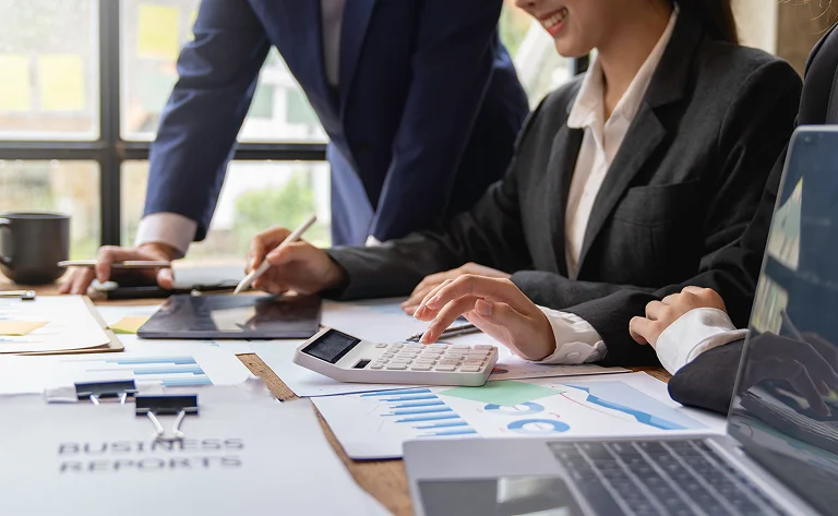 business teamwork with charts and technology device
